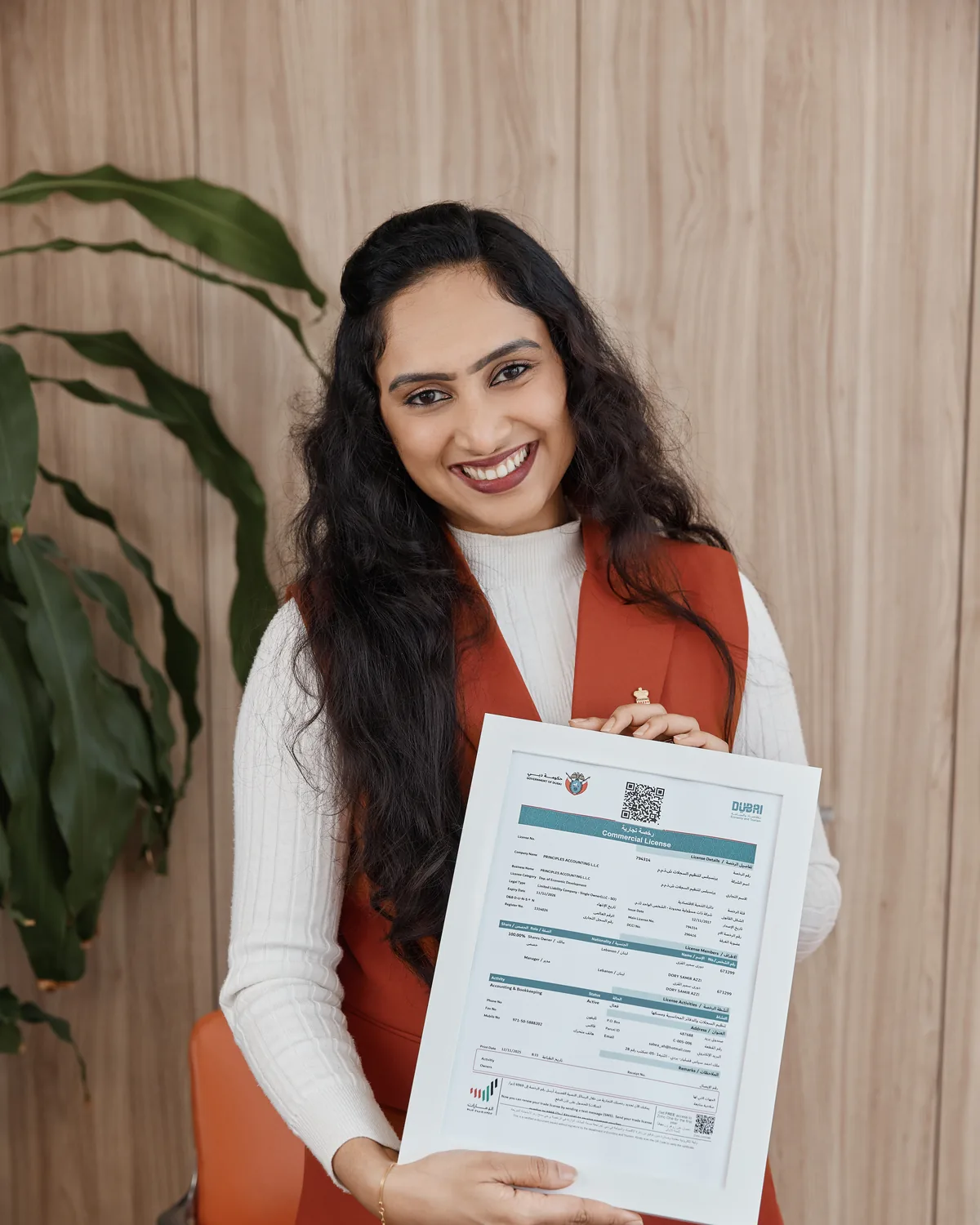 A founder holding her approved UAE trade licence